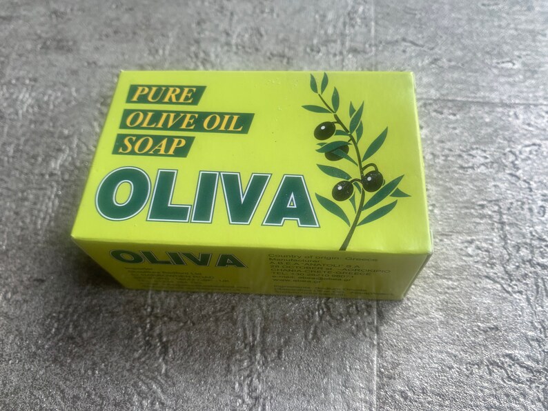 May include: A yellow box with green text and a green olive branch illustration. The text reads "PURE OLIVE OIL SOAP OLIVA".