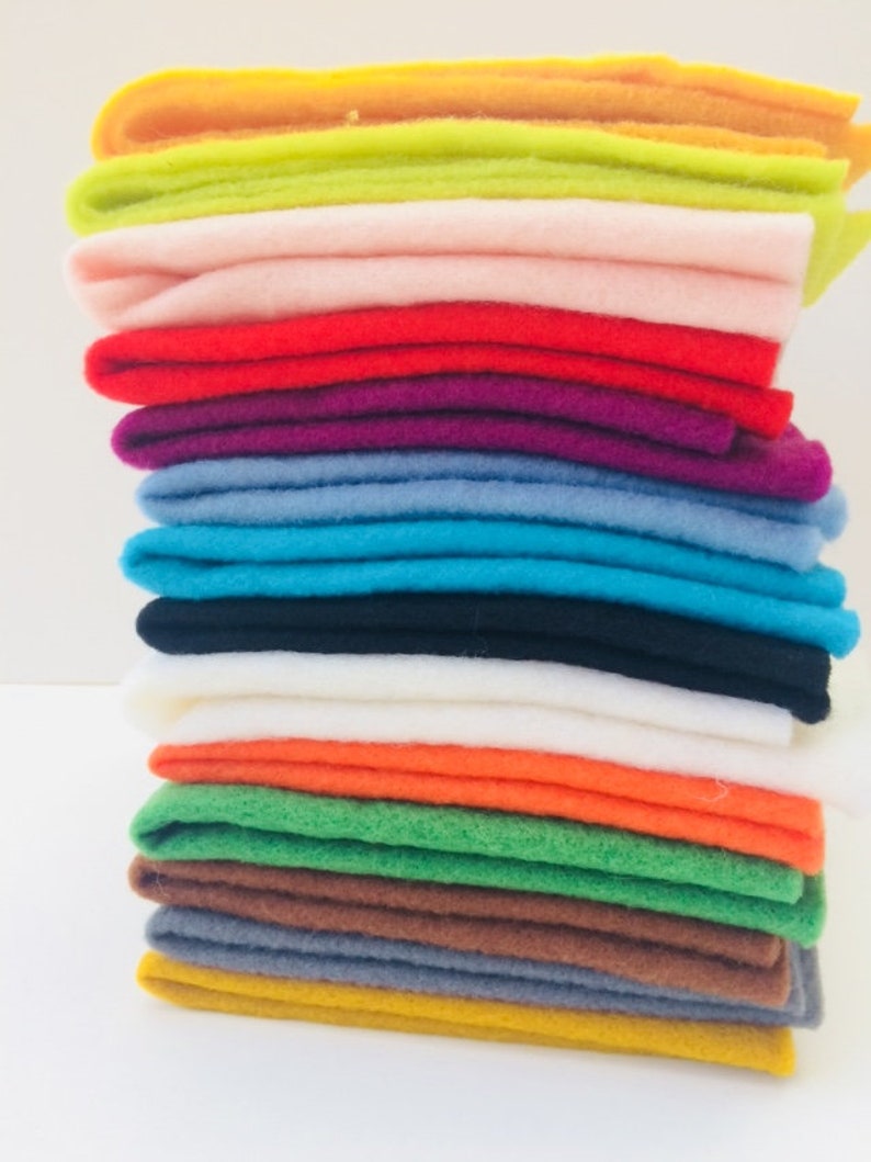May include: A stack of 16 different colored felt squares. The colors are yellow, green, pink, red, purple, blue, turquoise, black, white, orange, lime green, brown, gray, and gold.