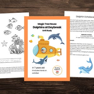 May include: A printable educational activity for children ages 4-7 about dolphins. The activity includes a yellow submarine with a dolphin inside, a coral reef coloring page, and instructions for a dolphin echolocation game. The text on the page reads "Magic Tree House Dolphins at Daybreak Unit Study" and "Reading Explorers".