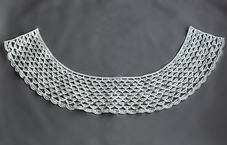 May include: White crocheted lace collar with a scalloped edge.