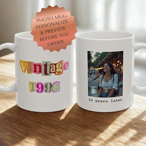 May include: White ceramic mug with a photo of a woman and the text "30 years later." The mug also features the text "Vintage 1996" in colorful letters. A sticker above the mug reads "Photo Mug, Personalize & Preview Before You Order."