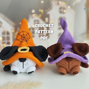 May include: Two crocheted Halloween dog toys, one with an orange hat and a spiderweb design, and the other with a purple hat.  The text "CROCHET PATTERN PDF" is visible in the image.