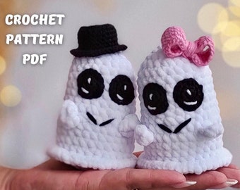 May include: Two white crocheted ghost amigurumi toys. One ghost wears a black top hat and the other wears a pink bow.  CROCHET PATTERN PDF.