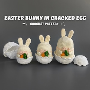 May include: Crocheted Easter bunny figurines in cracked egg shells. The bunnies are cream-colored with pink accents and carrot details. The text "EASTER BUNNY IN CRACKED EGG CROCHET PATTERN" is displayed above the figurines.