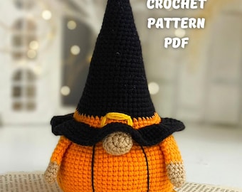 May include: A crocheted Halloween gnome with an orange pumpkin body, tan arms and nose, and a black witch hat. The hat has a yellow buckle. The text "CROCHET PATTERN PDF" is visible. The gnome is sitting on a piece of aged paper.