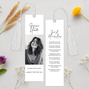 May include: Two white memorial bookmarks with silver tassels. One features a black and white photo and the text "Forever in our Hearts." The other bookmark has the text "Just A Memory Away" and a poem. The bookmarks are a remembrance gift.