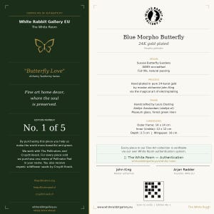 May include: A White Rabbit Gallery EU certificate of authenticity for a 24K gold plated Blue Morpho Butterfly. The document features a dark green left panel and a cream right panel with text details, dimensions of 14x14 cm, and a QR code.