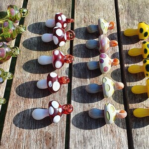 Glass mushrooms all colors, on table