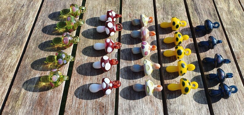 Glass mushrooms all colors, on table