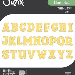 May include: A set of 26 Thinlits dies by Eileen Hull, featuring the complete alphabet in a bold, serif font. The letters are a light yellow color and are displayed against a white background. The Sizzix logo is at the top left.