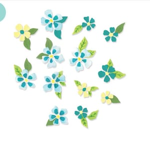 Puede incluir: Una colección de flores de papel azules y amarillas con hojas verdes. Las flores están dispuestas en un patrón aleatorio sobre un fondo blanco.