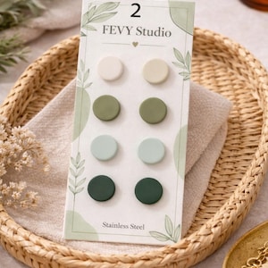May include: A set of three ceramic mugs with a speckled, matte finish. The mugs are in shades of cream, light gray, and dark gray. Each mug has a simple, minimalist design, perfect for coffee or tea.
