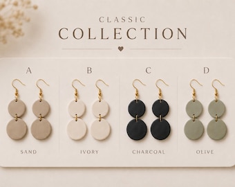 May include: Four pairs of double-circle drop earrings labelled Classic Collection, featuring gold-tone hooks. Colours include sand, ivory, charcoal, and olive. Each pair consists of two stacked circular discs suspended from a metal hook, arranged in a row.