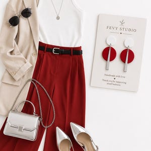 Puede incluir: Un blazer beige, una camiseta sin mangas blanca acanalada, pantalones rojo oscuro con cintur&oacute;n negro, bolso plateado, tacones plateados, gafas de sol negras, collar plateado y pendientes geom&eacute;tricos en una tarjeta de Fevy Studio.