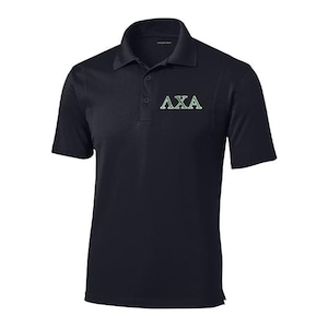 May include: Black polo shirt with short sleeves and a collared neckline. The shirt features the Greek letters ΛXA in green on the chest. The shirt has a button-down placket and is made of a smooth, likely athletic, fabric.