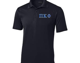 May include: A black short-sleeved polo shirt with a blue and gold embroidered Greek letter fraternity logo that says "ΠΚΦ".