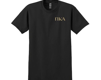 May include: Black short-sleeved t-shirt with the letters "PKA" printed in gold on the front.