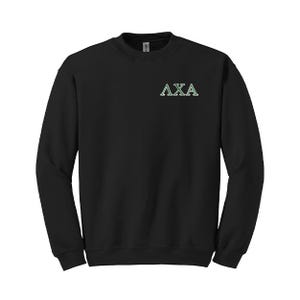 May include: Black crewneck sweatshirt with the Greek letters ΛXA in white with green accents on the upper left chest. The sweatshirt has long sleeves and a ribbed neckline, cuffs, and hem.