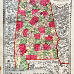 May include: A vintage map of Alabama, showing the state's counties and major cities. The map is printed in red, green, and yellow, with a scale and a title that reads "Tunison's Alabama".