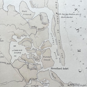 May include: A vintage nautical map featuring the Hereford Inlet area, with detailed labels of islands, sounds, and channels. The map includes place names like Jenkins Sound, Hereford Inlet, and Stone Harbor, with depth markings and a compass rose.