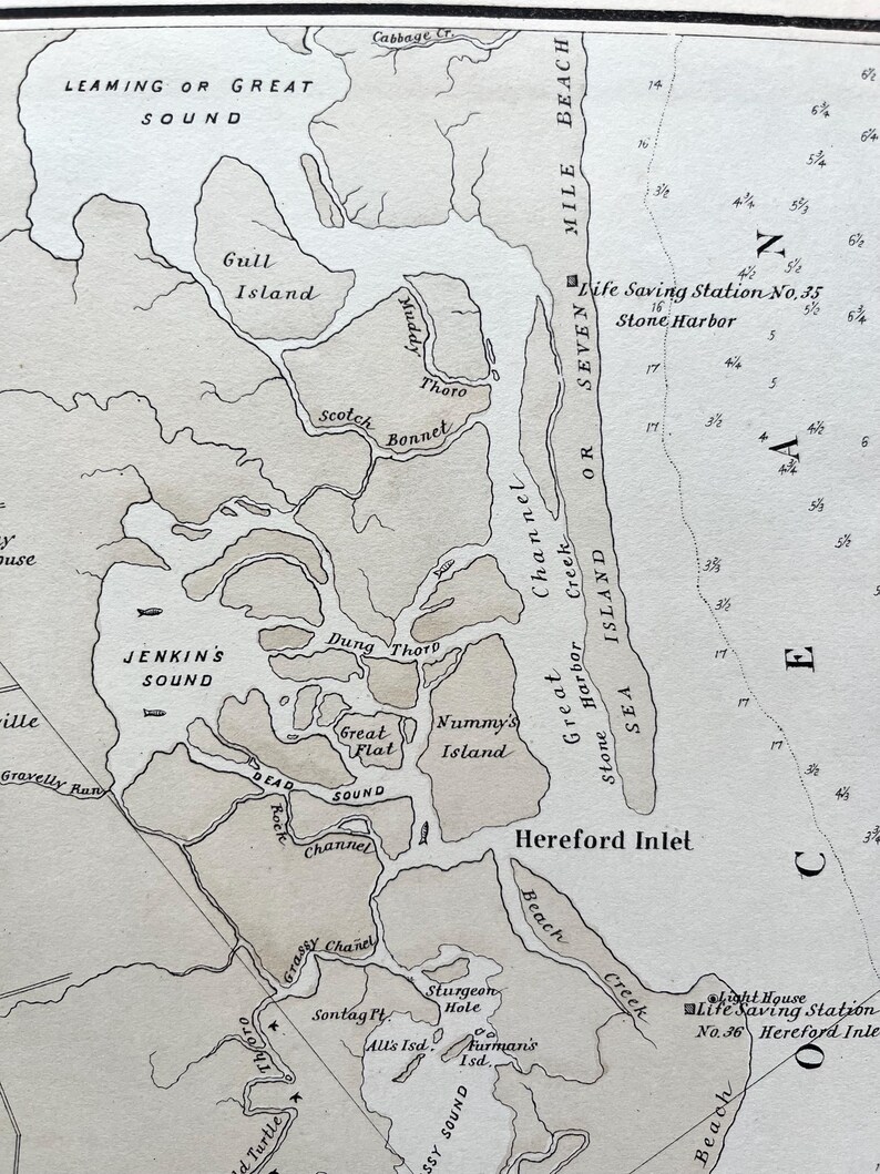 May include: A vintage nautical map featuring the Hereford Inlet area, with detailed labels of islands, sounds, and channels. The map includes place names like Jenkins Sound, Hereford Inlet, and Stone Harbor, with depth markings and a compass rose.