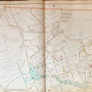 May include: A vintage map of West Orange, New Jersey, showing streets, parks, and property boundaries. The map is printed in black and white with colored accents, including blue for water features and green for parks. The map is titled "Part of West Orange" and includes a scale and compass.