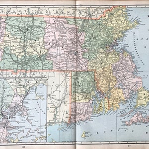 May include: A vintage map of Massachusetts and Rhode Island, with detailed geographical features and place names. The map is printed on aged paper, featuring a color palette of greens, pinks, and yellows. The Atlantic Ocean is labeled, and the map includes a smaller inset of Boston.