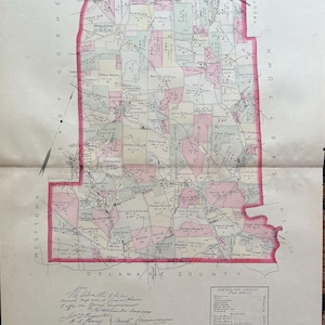 May include: A historical map of Willistown, Pennsylvania, featuring hand-colored land parcels in pink, yellow, and grey. The map includes detailed property owner names, road networks, a post office index, and a scale of one hundred perches to one inch.