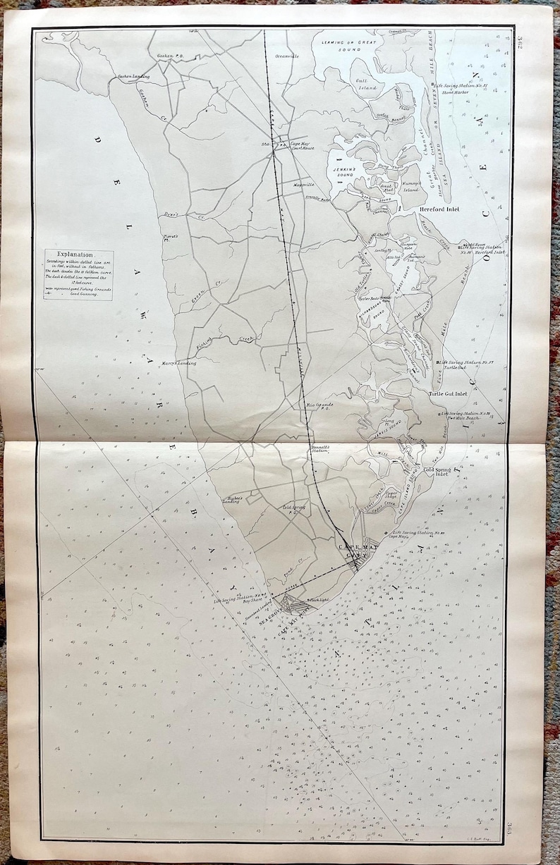 May include: Antique nautical map of the New Jersey coastline, featuring detailed depictions of bays, inlets, and coastal towns. The map is printed in shades of gray and black, with text labels and navigational markers. The map is folded in half.