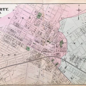 May include: A vintage map of East Liberty, Pittsburgh, Pennsylvania, from 1878. The map shows the city's streets, parks, and buildings. The map is printed in black and white with colored accents.