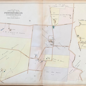 May include: A vintage map of properties along the Pennsylvania Railroad in Overbrook and Malvern, Pennsylvania. The map shows the names of property owners and the acreage of each property. The map is divided into sections, each with a different color.