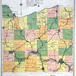 May include: A vintage map of Cattaraugus County, New York, with a legend and key for roads, towns, and railroads. The map is divided into townships, with each township colored differently. The map is printed on a white background with black lines and text.