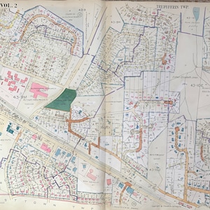 May include: A black and white map of a neighborhood with street names and property lines. The map is divided into sections labeled with numbers and letters. The map is titled "Main Line, Vol. 2" and "Tredyffrin Twp."