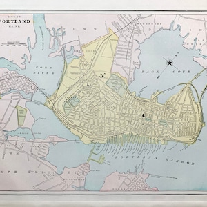 May include: A vintage map of Portland, Maine, showing the city's streets, waterways, and landmarks. The map is in a light blue, yellow, and green color scheme. The text "CITY OF PORTLAND MAINE" is at the top of the map.