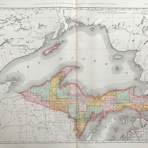 May include: A vintage map of Northern Michigan, showing the counties and major lakes. The map is from Rand McNally & Company's Indexed Atlas of the World.