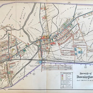 May include: A vintage map of Downingtown, Pennsylvania, showing the layout of streets, buildings, and businesses. The map is printed on paper and has a scale of 300 feet to an inch. The map is divided into sections labeled "East", "West", "North", and "South".