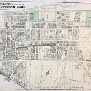 May include: A black and white map of the Eleventh and part of the Thirteenth Ward, showing streets, avenues, and buildings. The map is titled "Eleventh and part of Thirteenth Ward" and includes the scale "Scale 200 feet per inch."
