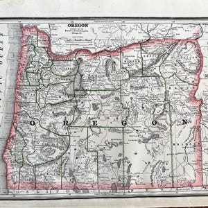 May include: A vintage map of Oregon, printed in black and white with red and green accents. The map shows the state's counties and major rivers. The title "Oregon" is printed at the top of the map, along with the publisher's name, "People's Publishing Co., Chicago."