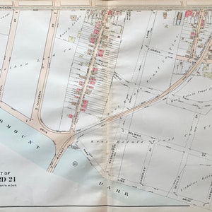 May include: A vintage map of a section of Philadelphia, Pennsylvania, showing streets, parks, and property lines. The map is titled "Part of Ward 21" and includes the text "Scale 100 feet to an inch".