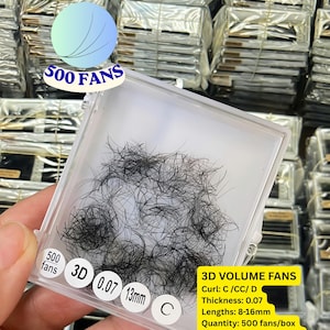 May include: A clear plastic tray containing black 3D volume eyelash fans. The tray features labels reading 500 fans, 3D, 0.07, 13mm, and C. A yellow sticker lists specifications: 3D VOLUME FANS, Curl: C/CC/D, Thickness: 0.07, Lengths: 8-16mm, Quantity: 500 fans/box, Material: PBT from Korea, Wholesale, OEM, ODM available.