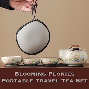 May include: A portable tea set featuring a teapot and three cups, all adorned with floral designs in shades of pink and blue. The set includes a carrying case. The text on the image reads "Blooming Peonies Portable Travel Tea Set."