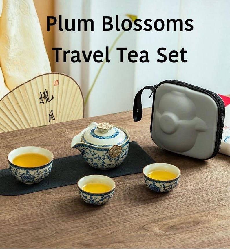 Puede incluir: Un juego de t&eacute; de viaje con el texto "Plum Blossoms Travel Tea Set". El juego incluye una tetera, tres tazas de t&eacute; y un estuche. La tetera y las tazas tienen un dise&ntilde;o floral azul y blanco. El t&eacute; es de color amarillo dorado.