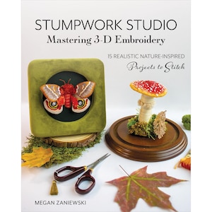 May include: A book cover titled "STUMPWORK STUDIO Mastering 3-D Embroidery" features a green velvet square with a framed embroidered moth. A mushroom display and scissors are also visible. The book is about realistic nature-inspired projects.