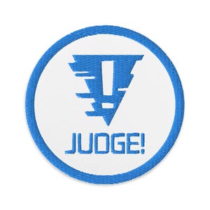 May include: Blue and white embroidered patch with an exclamation point in a triangle and the text "JUDGE!"
