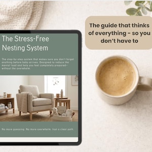 May include: A tablet displaying The Stress-Free Nesting System guide with text about baby preparation and a photo of a nursery chair. Next to it sits a beige ceramic mug and a text box stating, The guide that thinks of everything - so you don't have to.