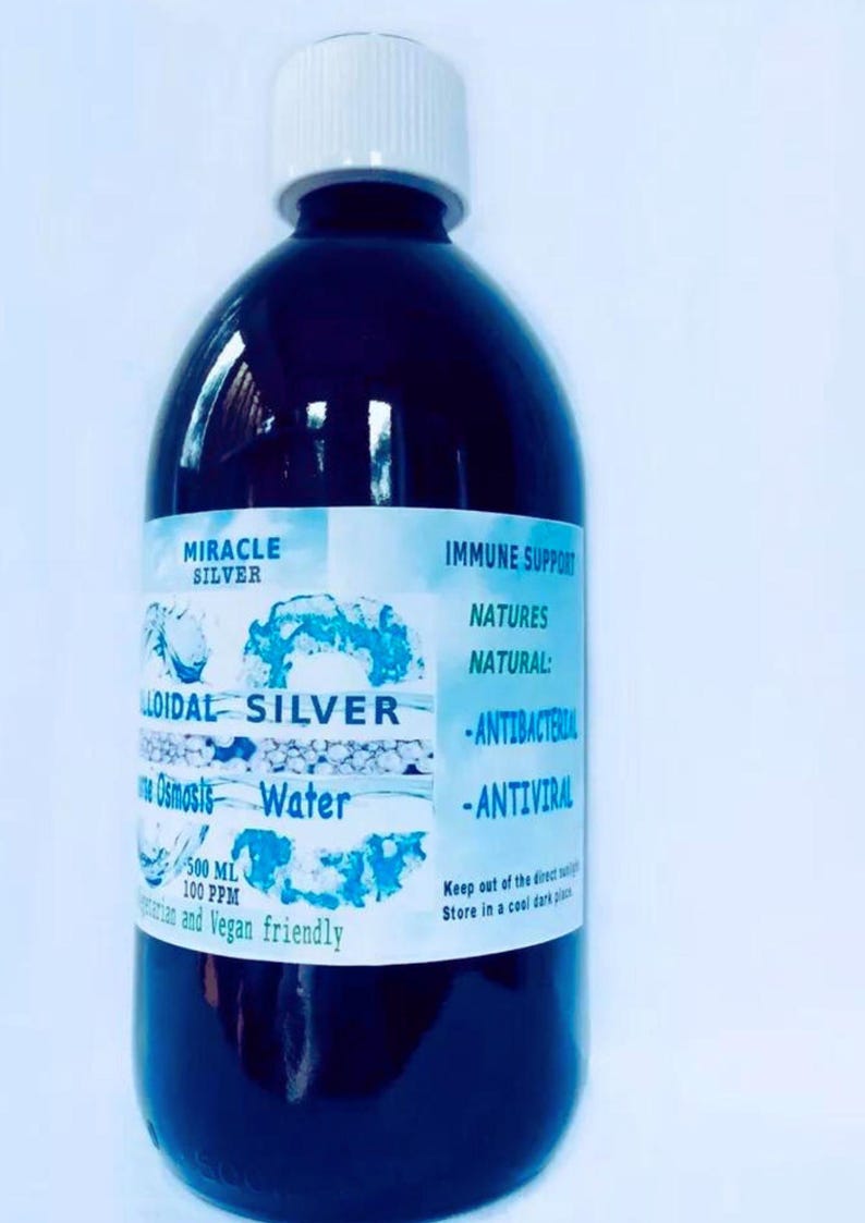 May include: A clear glass bottle with a white cap, containing a dark liquid. The label reads "Miracle Silver Colloidal Silver Osmosis Water 500 ml 100 ppm" and "Immune Support Natures Natural: -Antibacterial -Antiviral Keep out of the direct sunlight Store in a cool dark place".