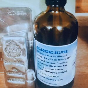 May include: A brown glass bottle with a white label that reads "COLLOIDAL SILVER". The label explains that the water is filtered using "REVERSE OSMOSIS" and that the bottle is refillable.