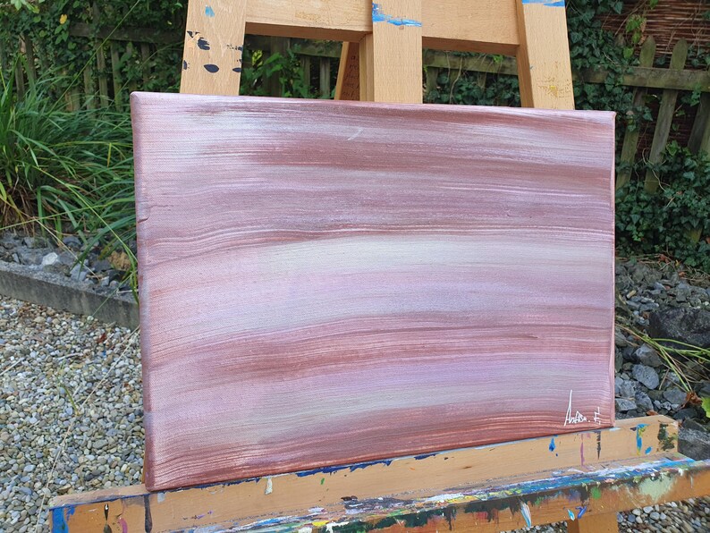 May include: Abstract painting on canvas with horizontal brushstrokes in shades of pink, white, and brown. The painting is signed in the bottom right corner.