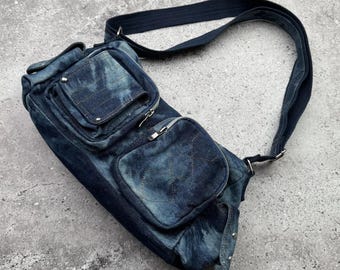 May include: A blue denim crossbody bag with multiple pockets and a adjustable strap. The bag has a tie-dye pattern.
