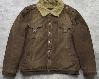 May include: A brown corduroy jacket with a faux fur collar. The jacket has two chest pockets with button closures, two side pockets, and a button-up front. The jacket has a classic, vintage style.